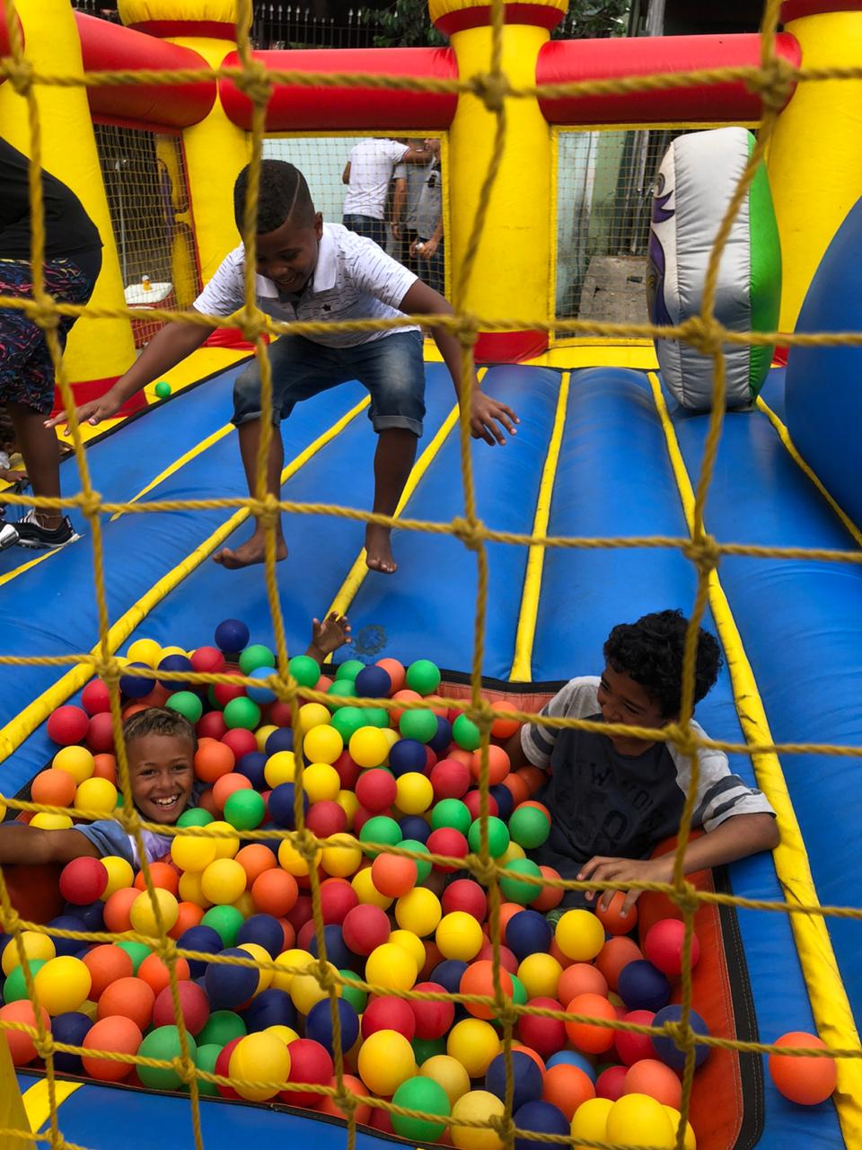 Imagem das crianças brincando na piscina de bolinha do brinquedo inflável